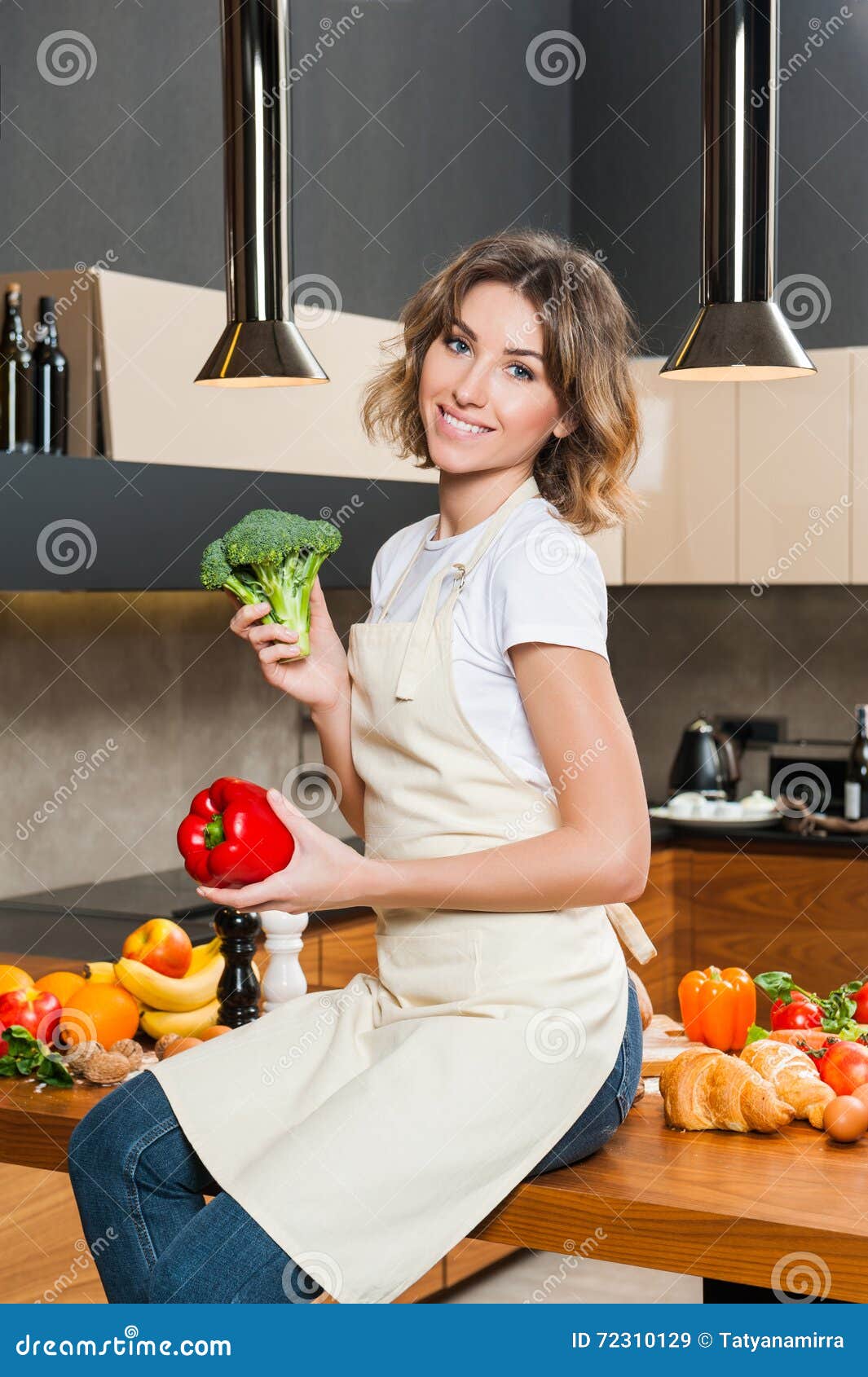 Pretty Housewife In The Kitchen Sitting On Table St