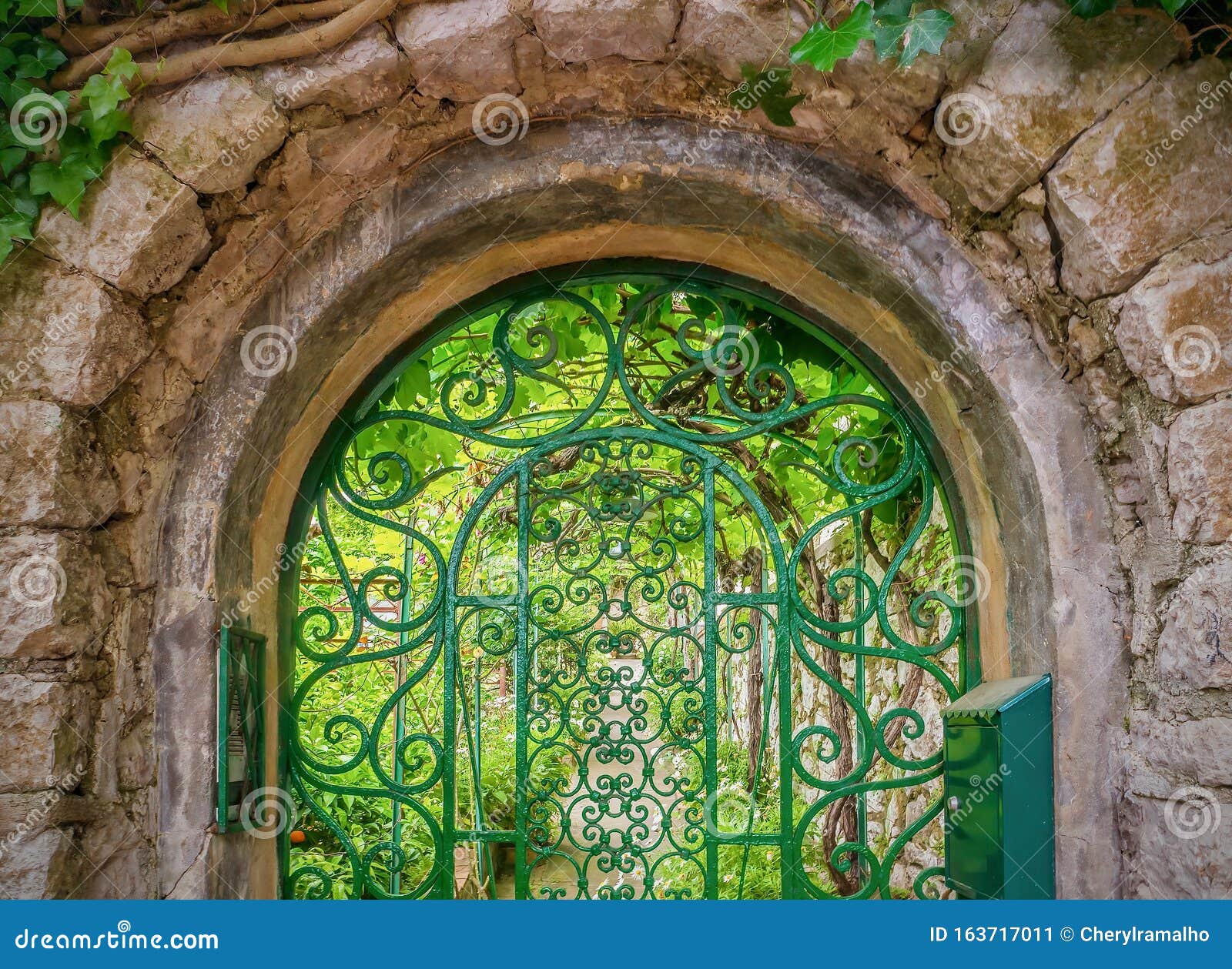 Pretty Iron Gate Leading To A Green Summer Garden Stock Image