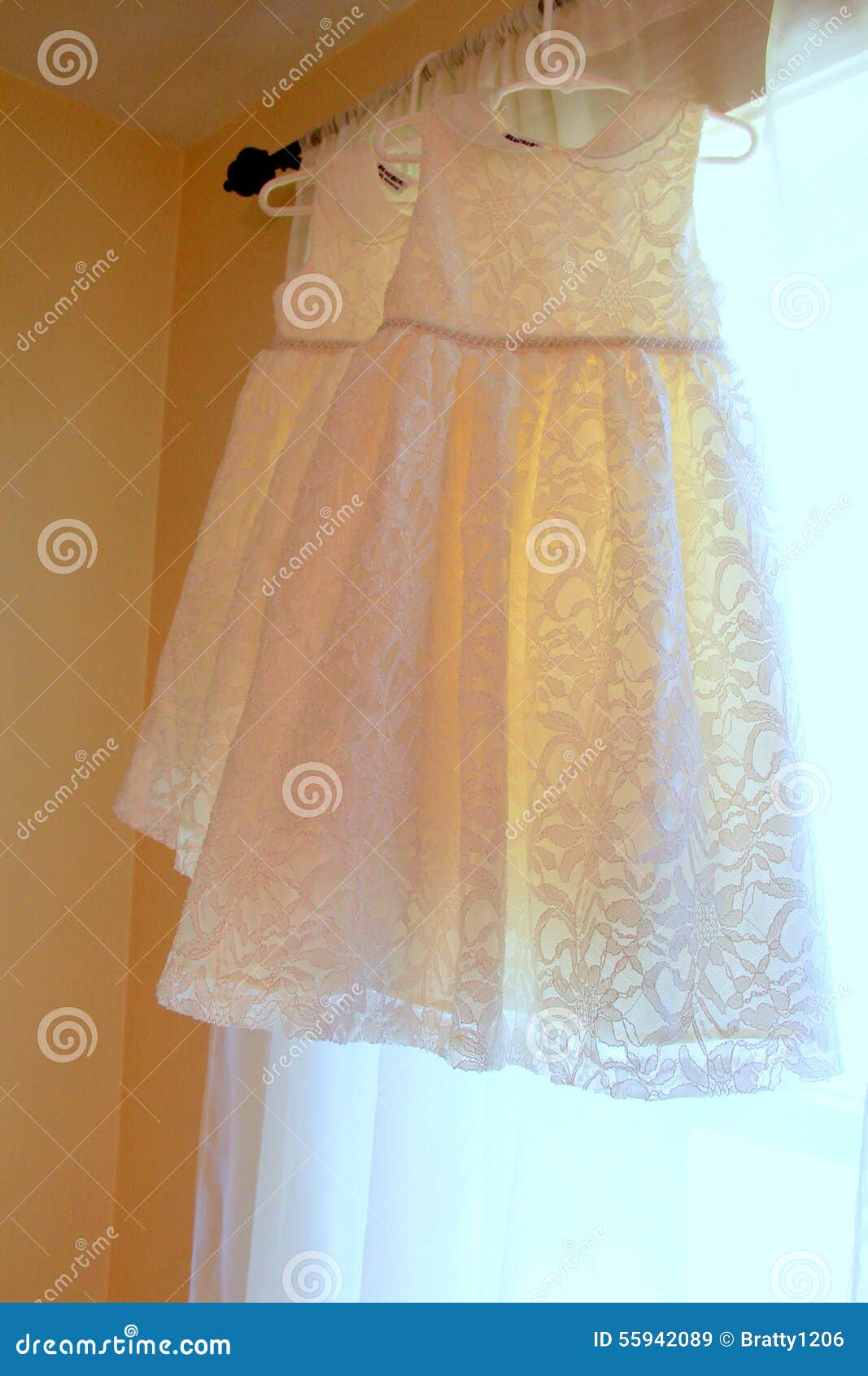 Pretty Lace Flower Girl Dresses Hanging in Window Stock Image - Image ...