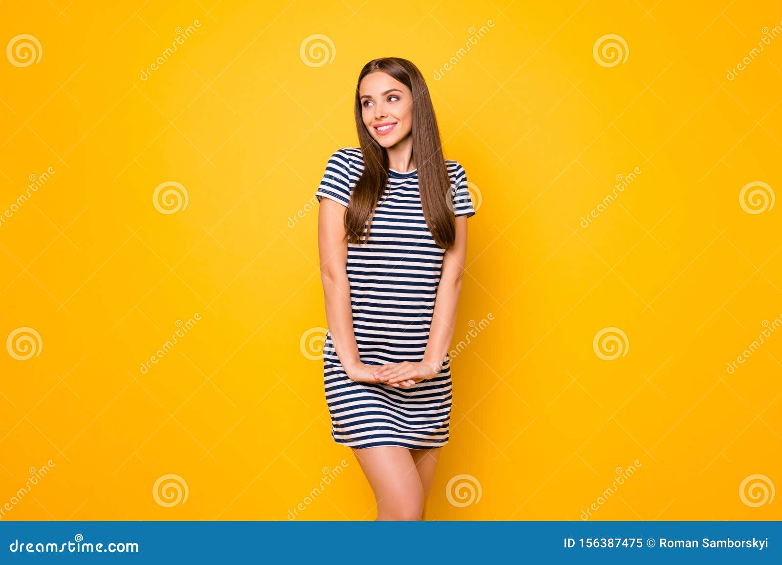 pretty lady with easy-going mood glad sunny weather wear striped white blue dress  yellow background