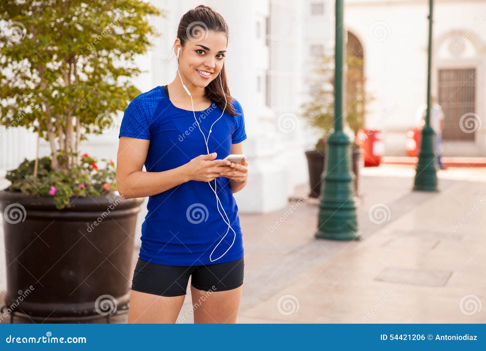 Pretty Latin Runner with Earbuds Stock Photo - Image of happy ...