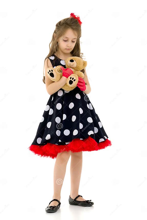 Pretty Long Haired Girl Wearing Polka Dot Dress Posing With Teddy Bear