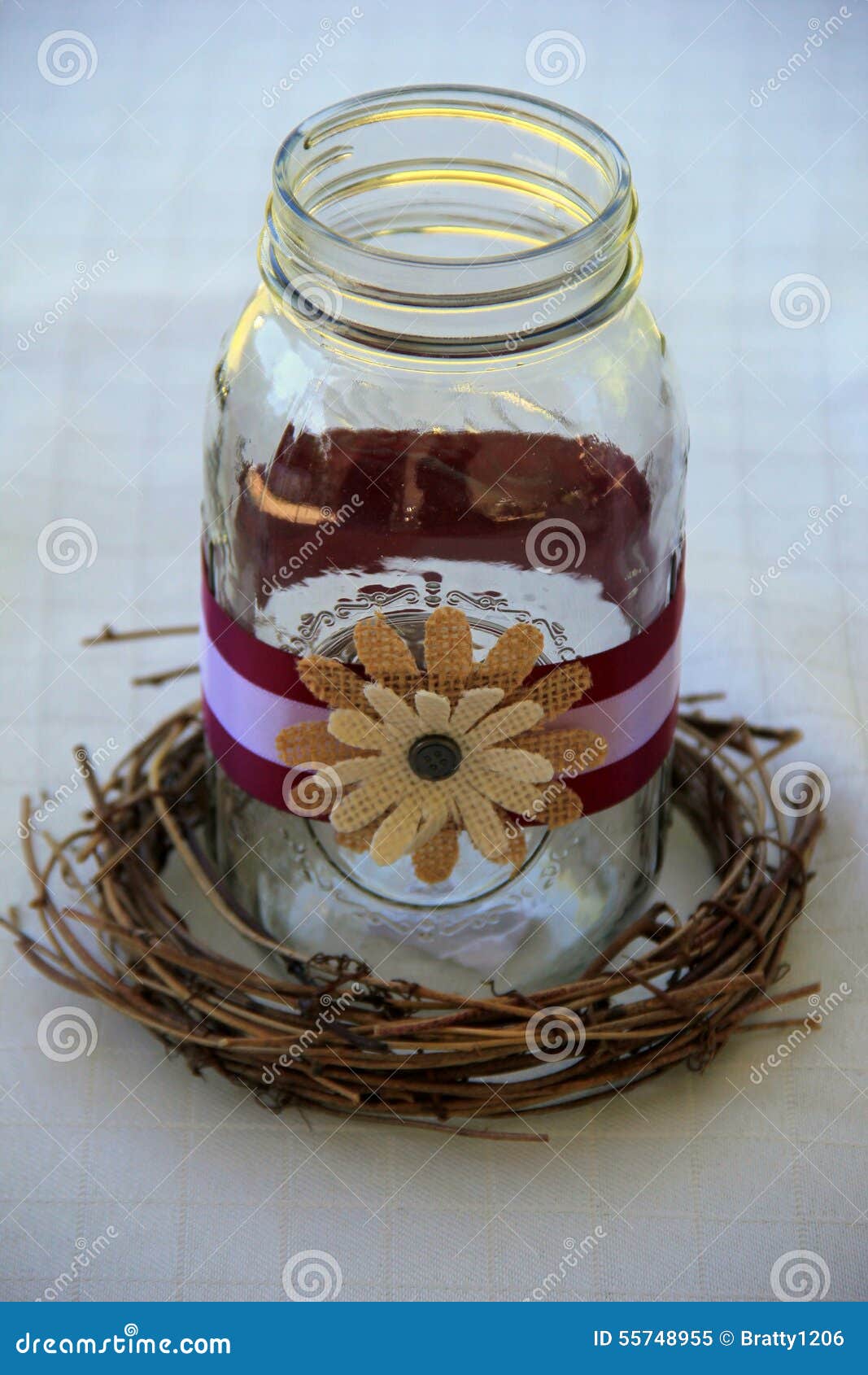 Pretty Mason Jar Decorated With Rustic Flowers And Ribbon