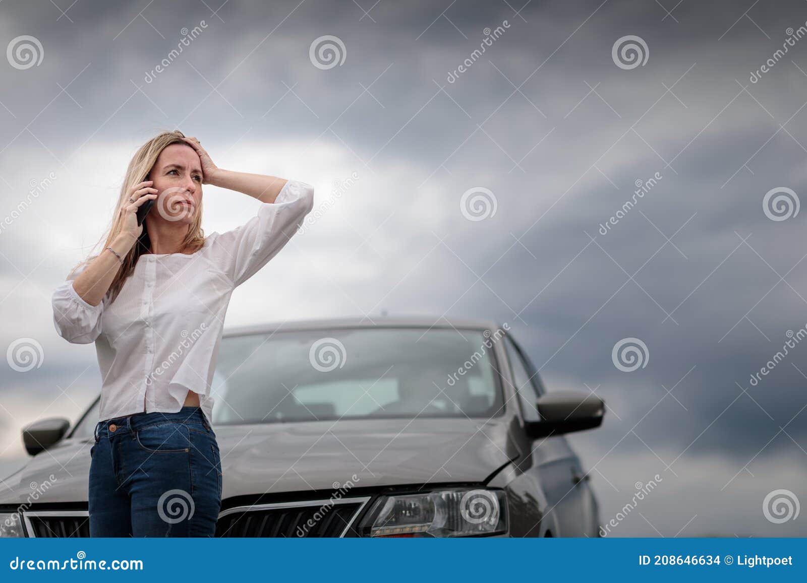 pretty middle aged woman having car troubles