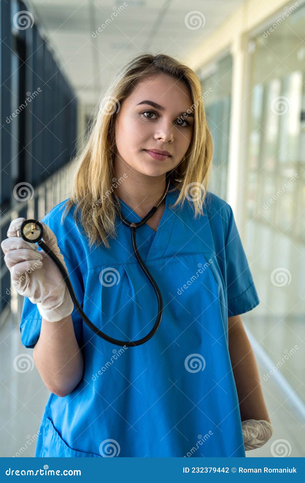 Pretty Nurse in Blue Uniform with Stetoscope Indoors in Modern Clinic ...