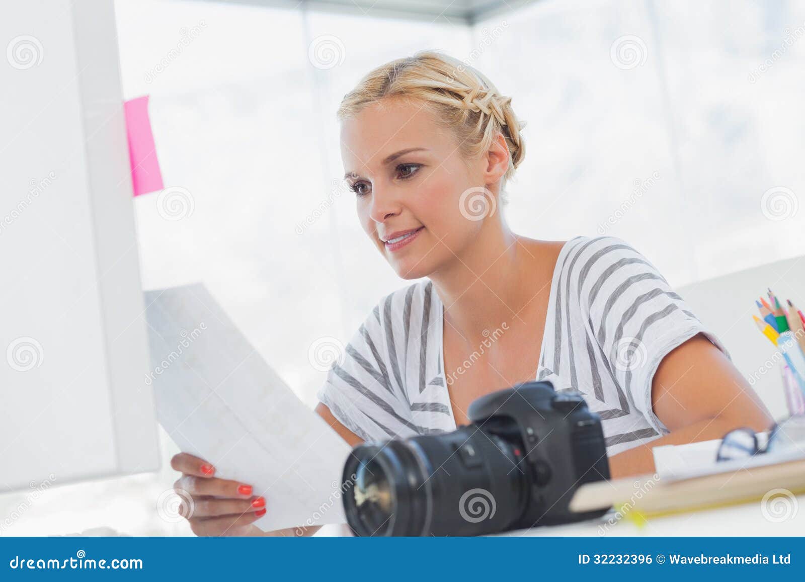 Pretty Photo Editor Looking at a Contact Sheet Stock Photo Image of