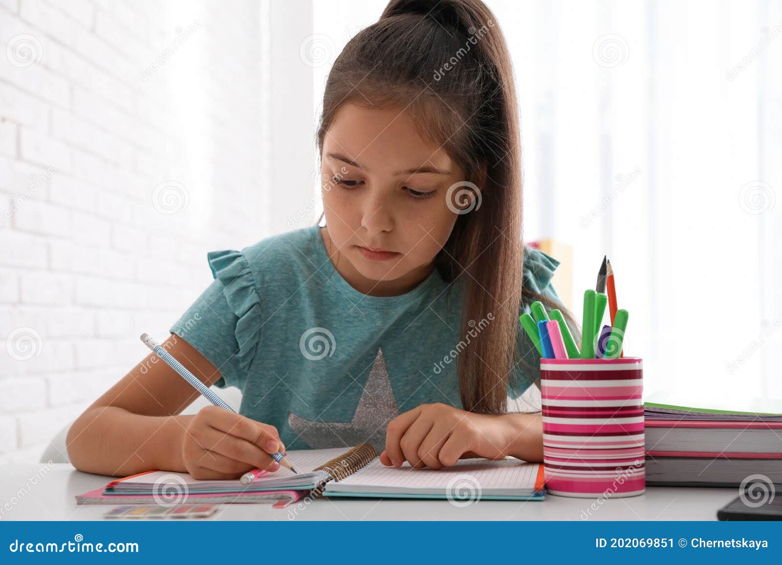 Teen Girl Doing Homework In Kitchen Portrait Stock Photo 