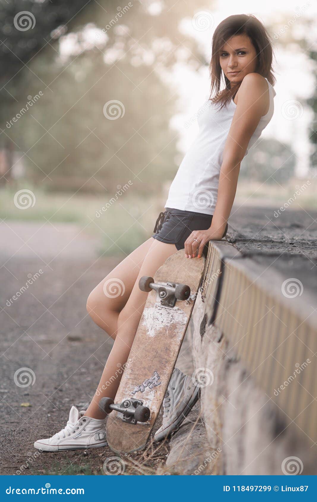 Pretty skater girl. Beautiful skater girl in summer city