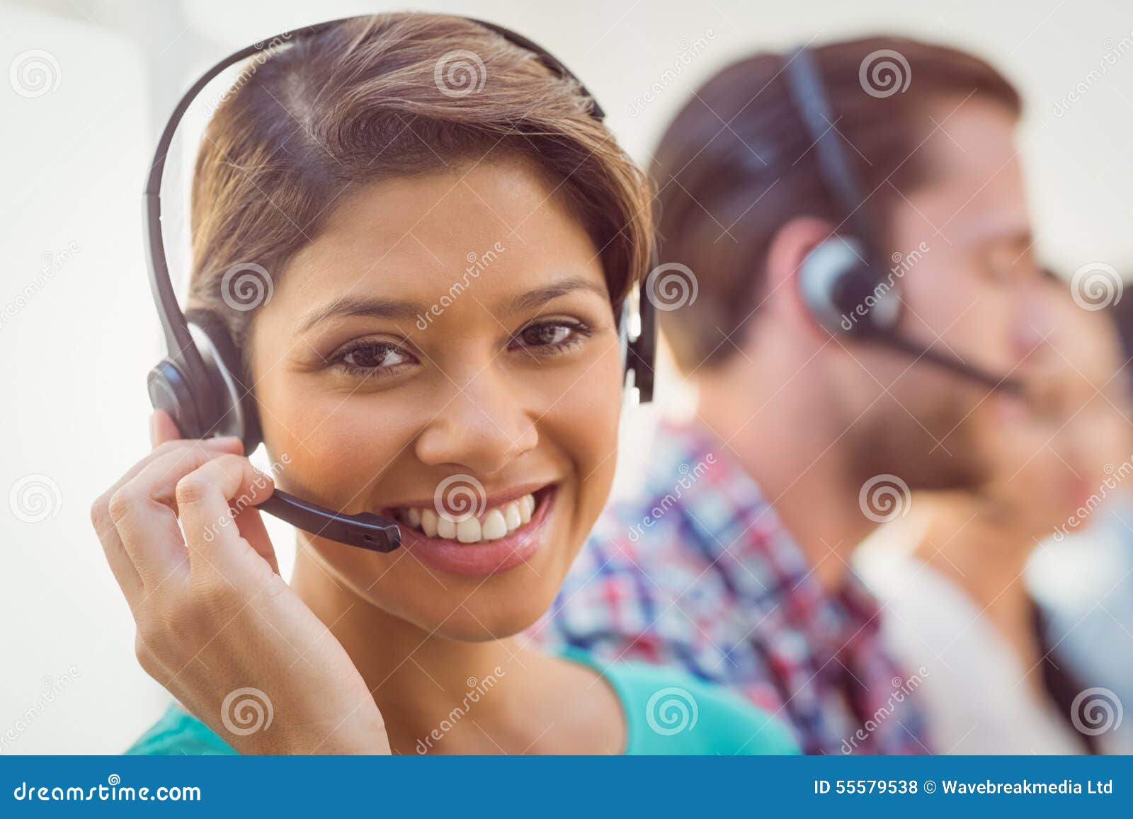 pretty smiling businesswoman working in a call centre