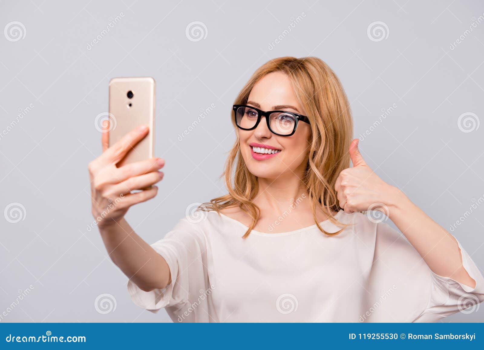 Pretty Smiling Woman With Blonde Hair In Spectacles Taking Selfie