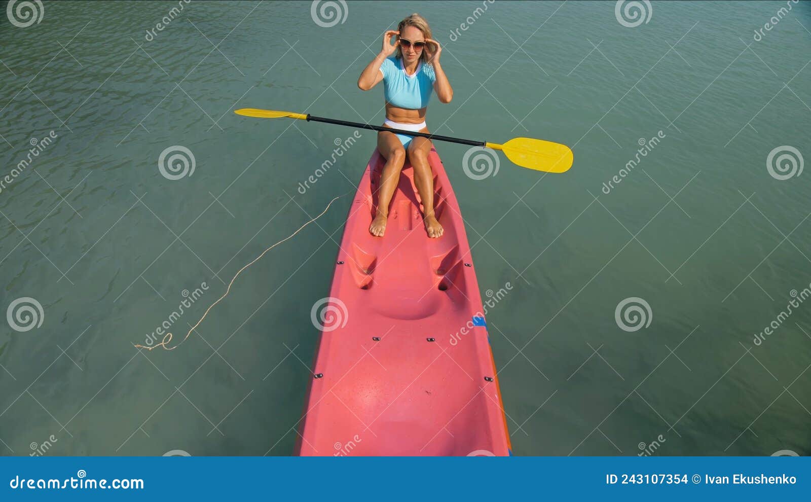 Pretty Sportive Blonde Lady in Stylish Swimsuit Sails on Pink Plastic ...