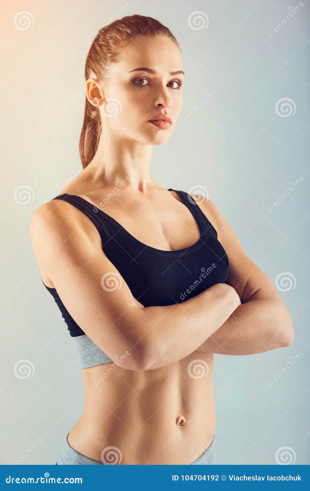 Pretty and Strong Sportswoman Posing with Arms Crossed Stock Photo - Image  of model, clothes: 104704192