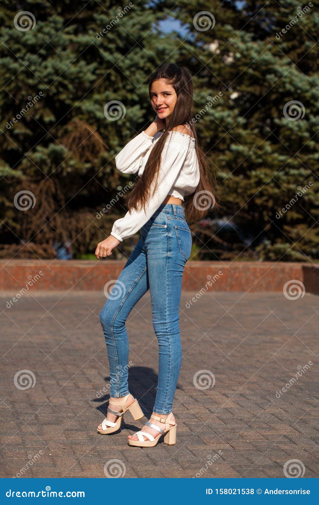 Pretty Stylish Brunette Girl in Blue Jeans and White Blouse Stock Photo ...