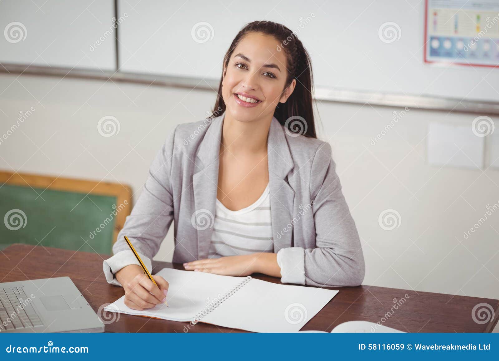the teacher is correcting her essay