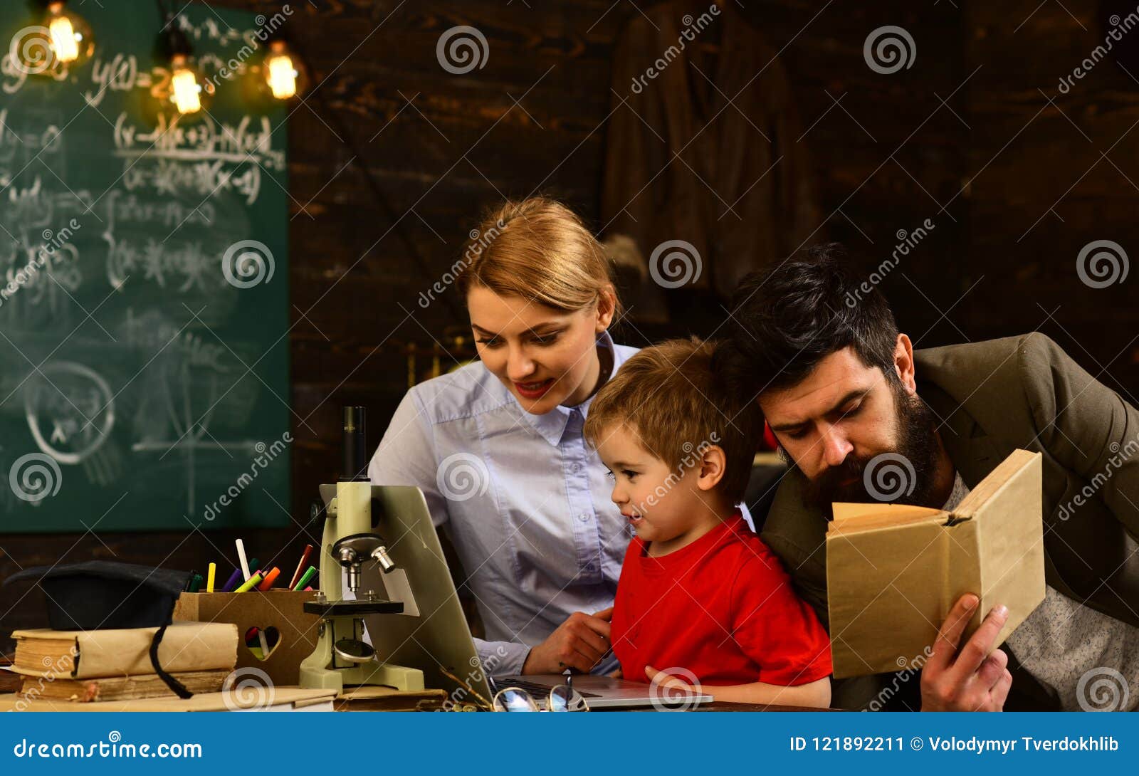 Download Pretty Teacher Helping Pupil In Classroom At The ...