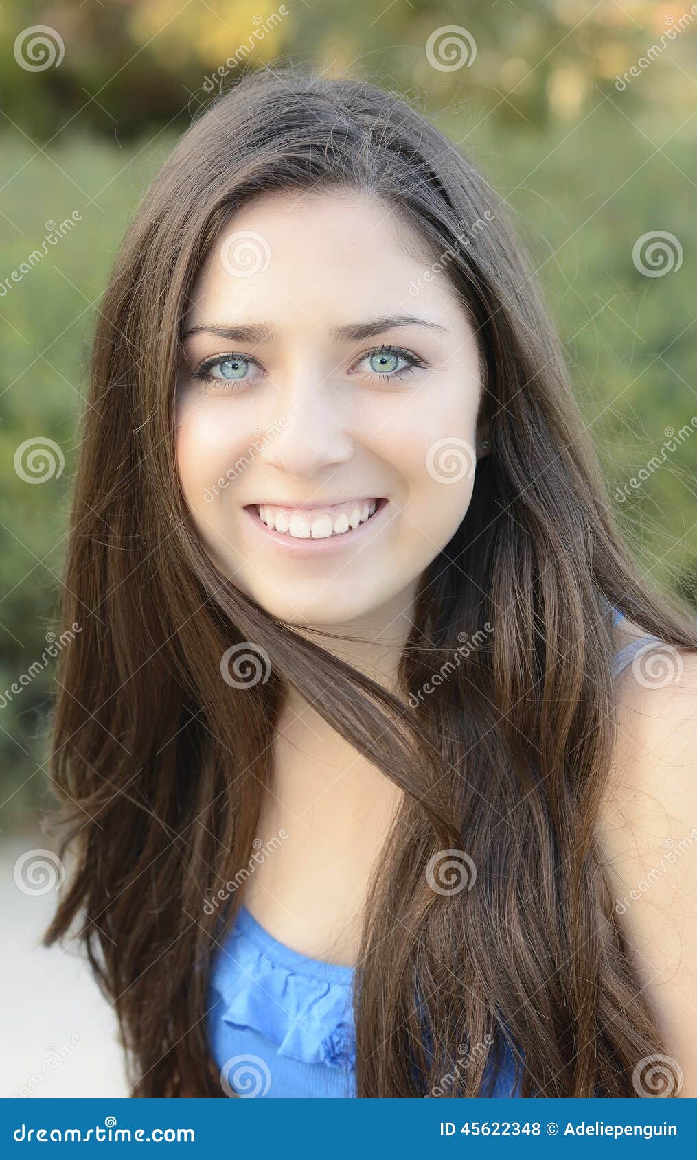 Premium Photo  A girl with brown hair and a blue eye is smiling