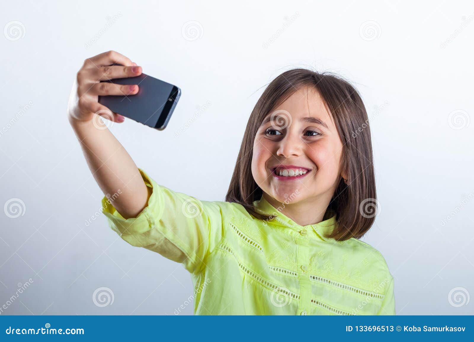 Pretty Teenage Girl with Mobile Phone in Studio. Selfie Stock Image ...