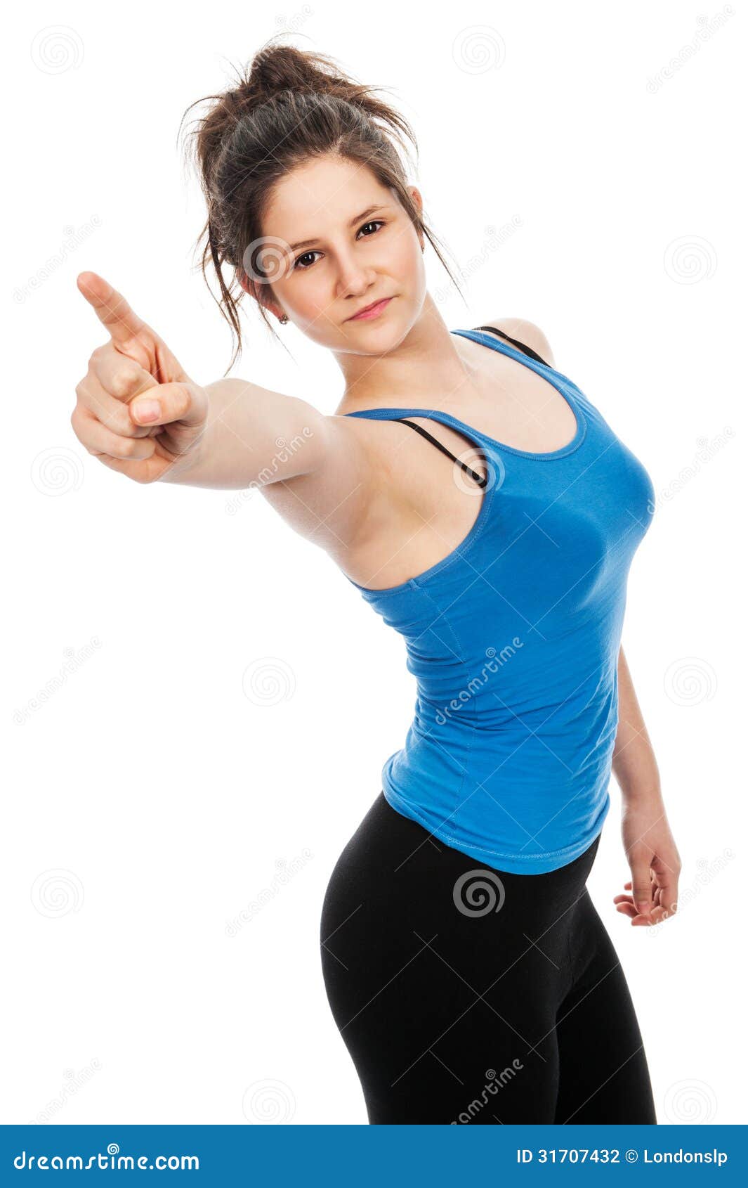 Pretty teenage girl pointing finger at camera. Pretty teenage girl pointing finger at camera looking quite angry. Shot in studio on white background.