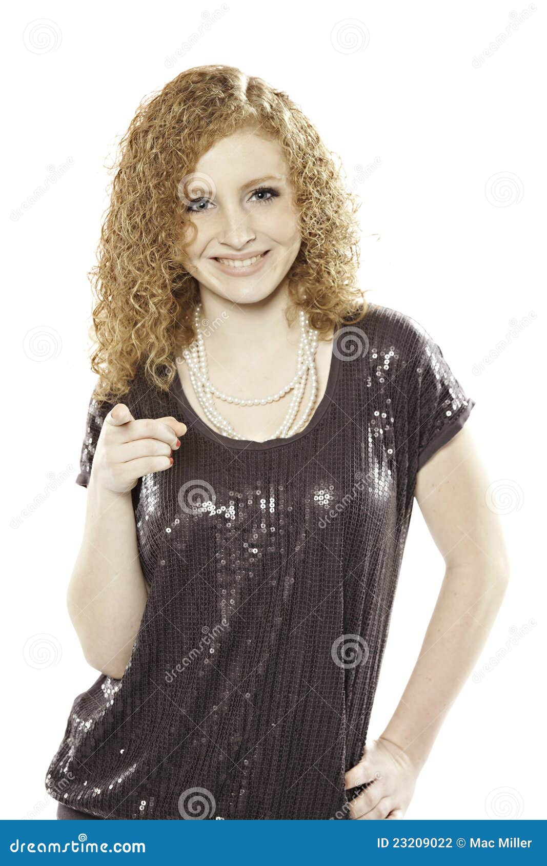 Pretty Teenage Girl Pointing on White. Pretty teenage female girl with red hair and brown shirt isolated pointing on a white background