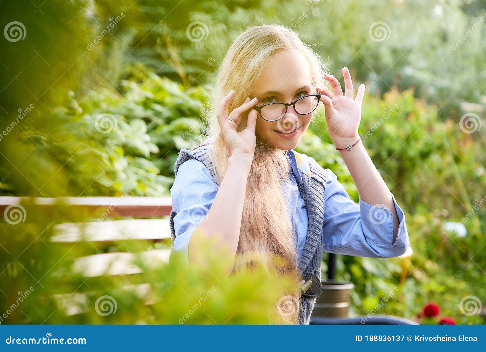 Pretty Teenage Girl 14 16 Year Old With Curly Long Blonde Hair And In Glasses In The Green Park 