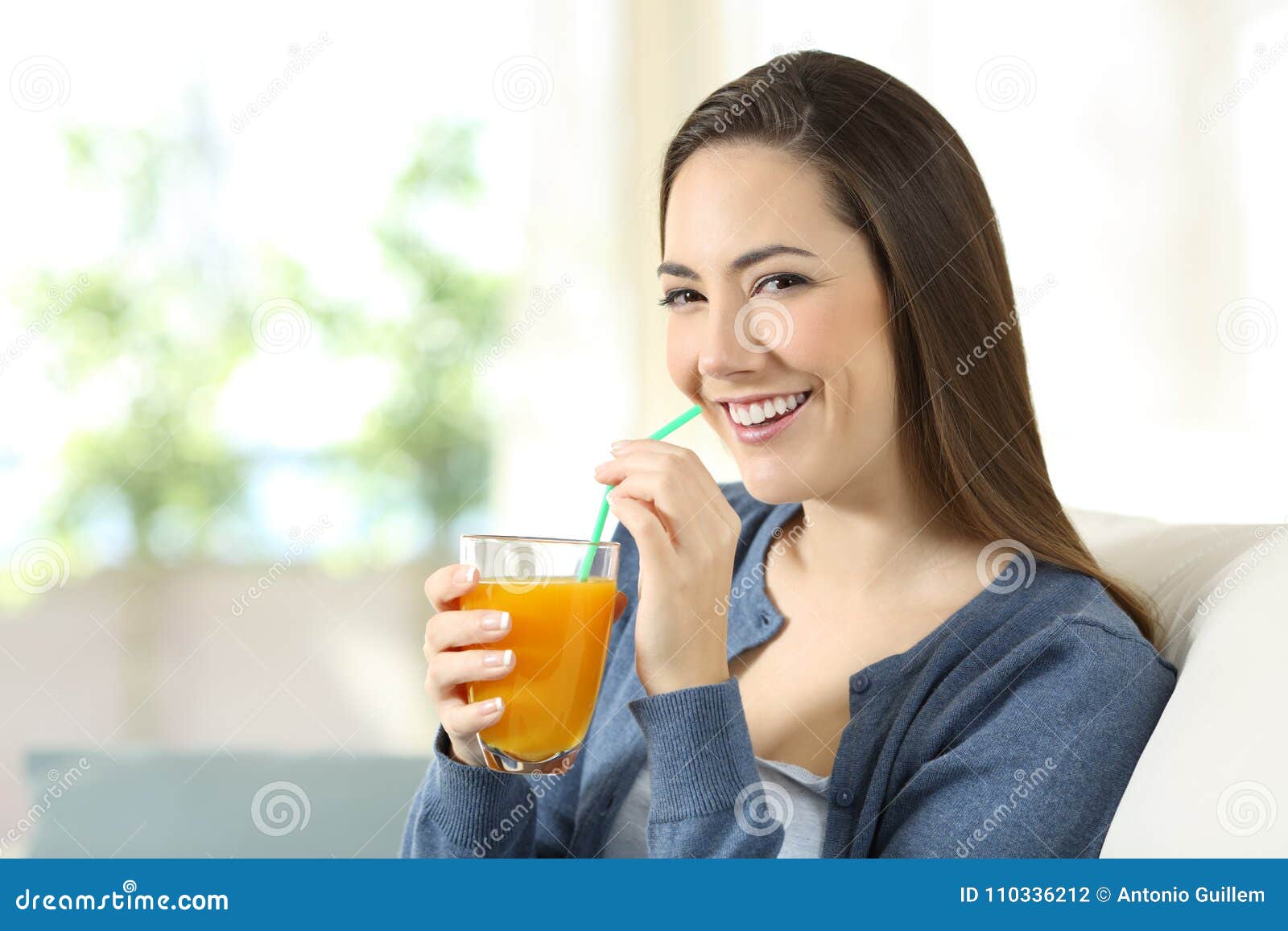 Pretty Woman Drinking Orange Juice Looking at Camera Stock Photo ...