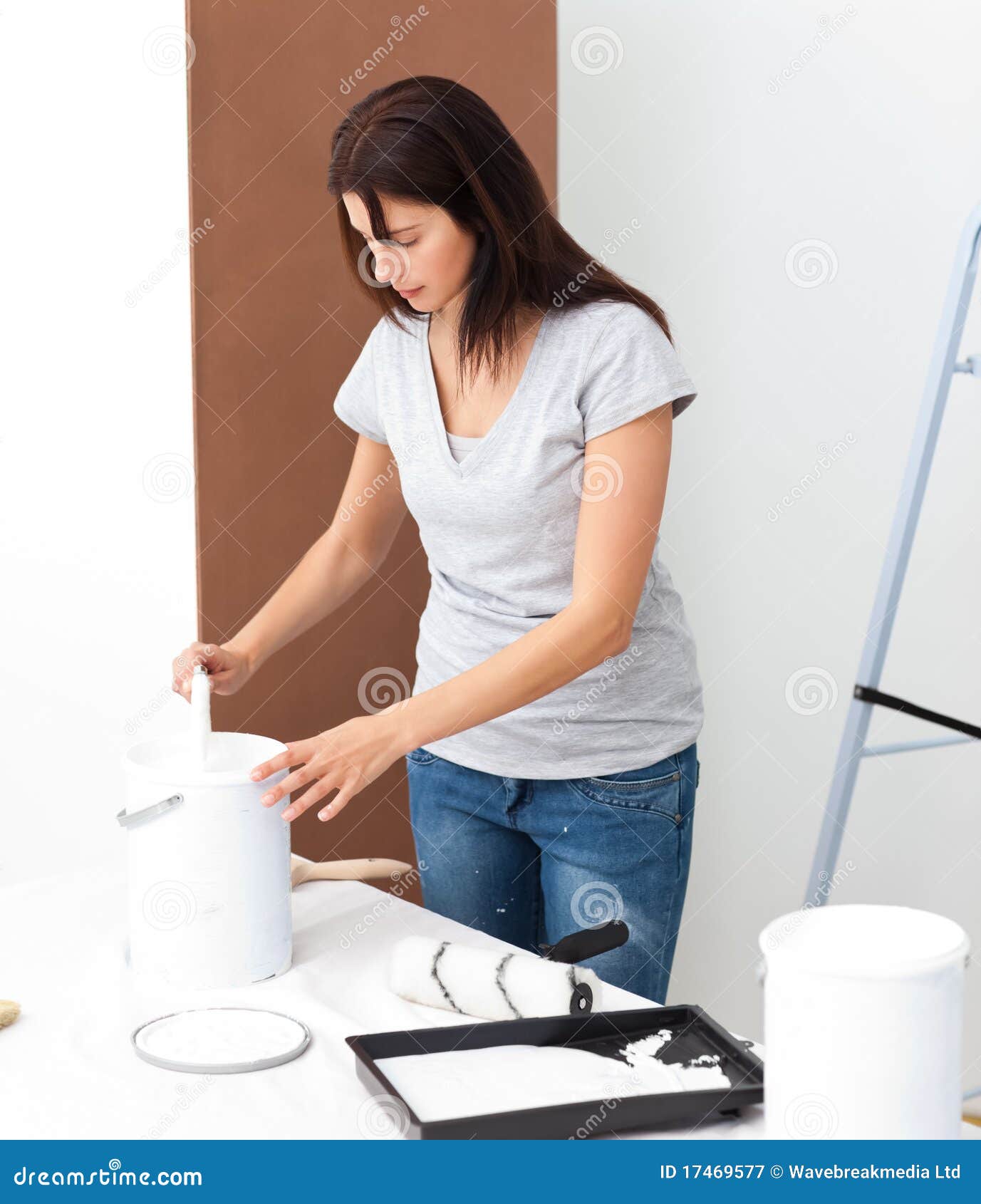 pretty woman preparing white paint to renovate