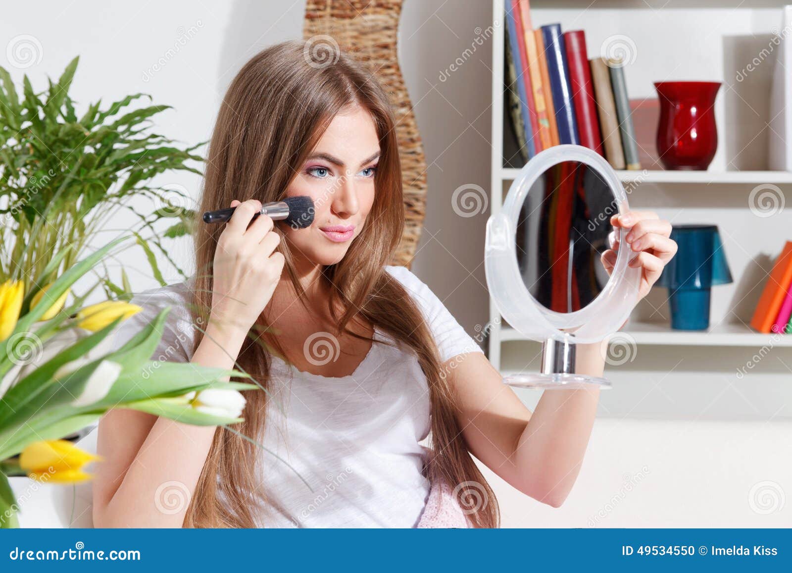 pretty woman putting makeup on