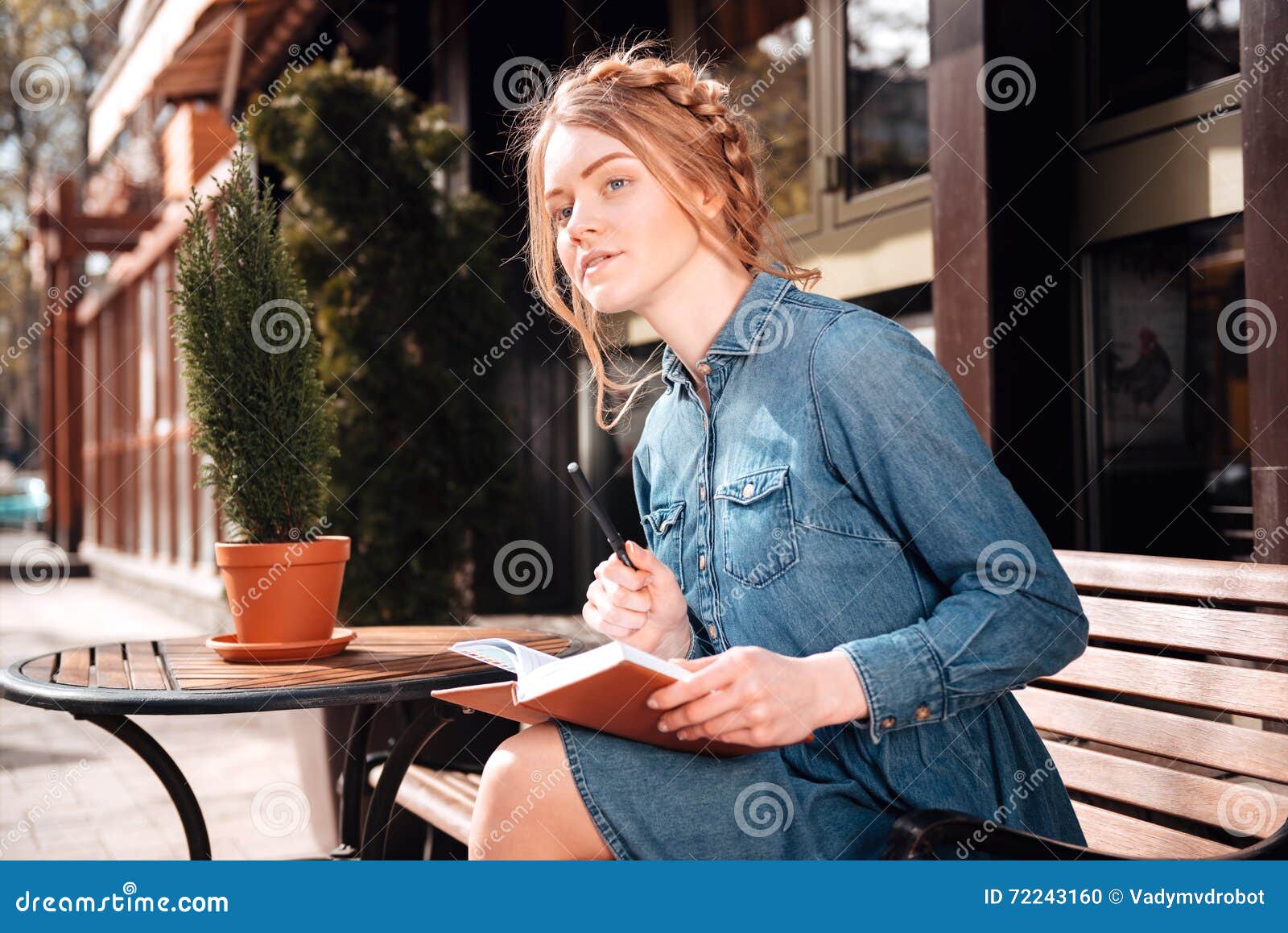 Pretty Woman Sitting and Writing in Notebook Outdoors Stock Photo ...