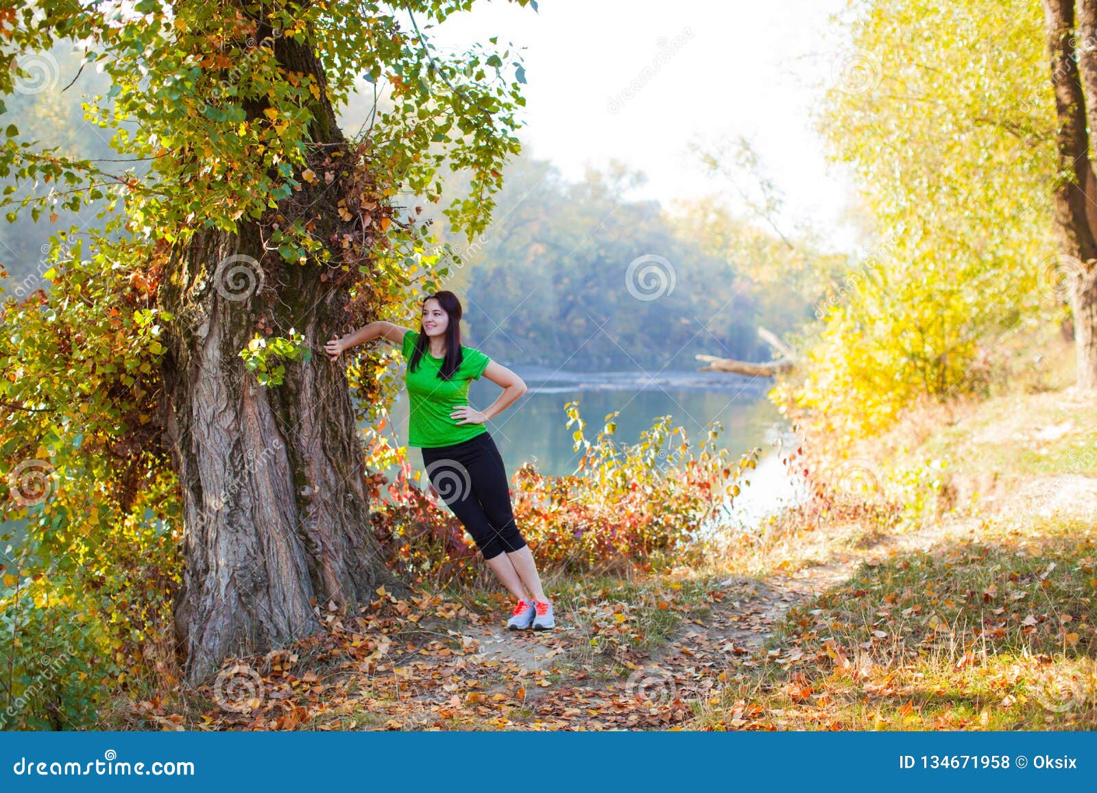 Pretty Woman Stretching Standing Near Large Old Tree Stock Photo ...