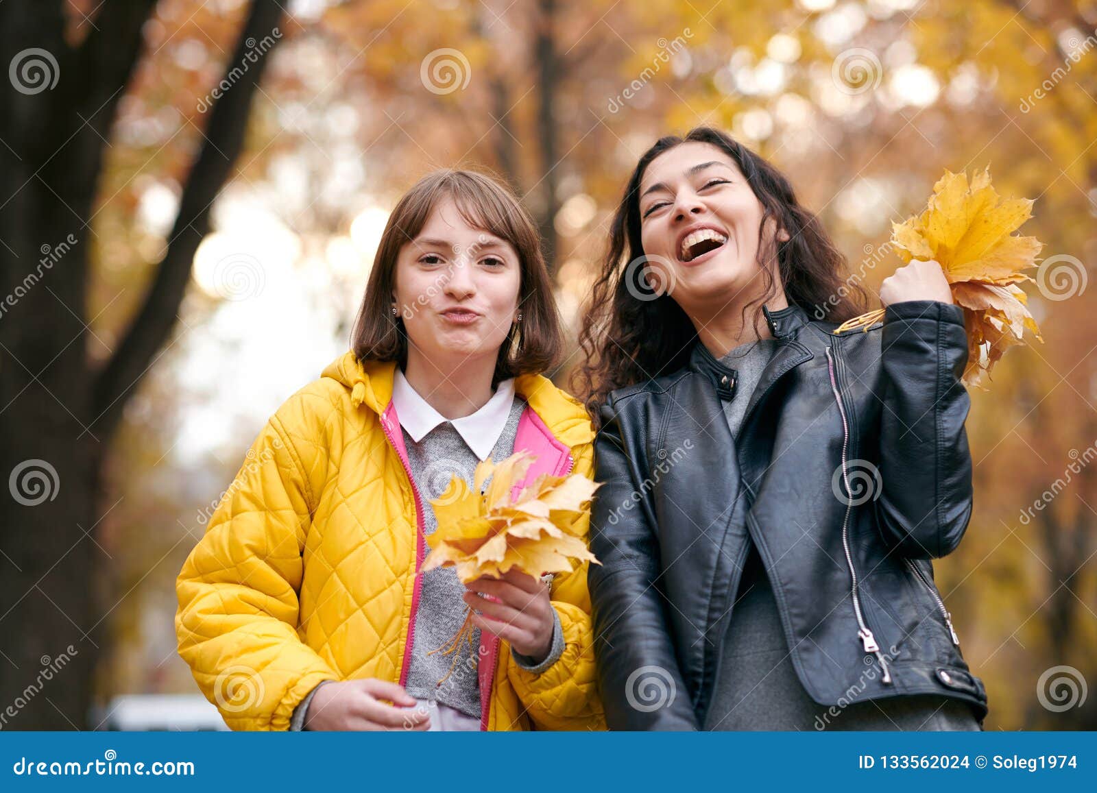 Pretty Woman and Teen Girl are Posing with Bunch of Maple`s Leaves in ...