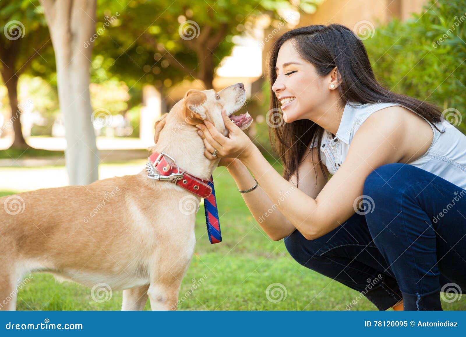 pretty woman about to kiss her dog
