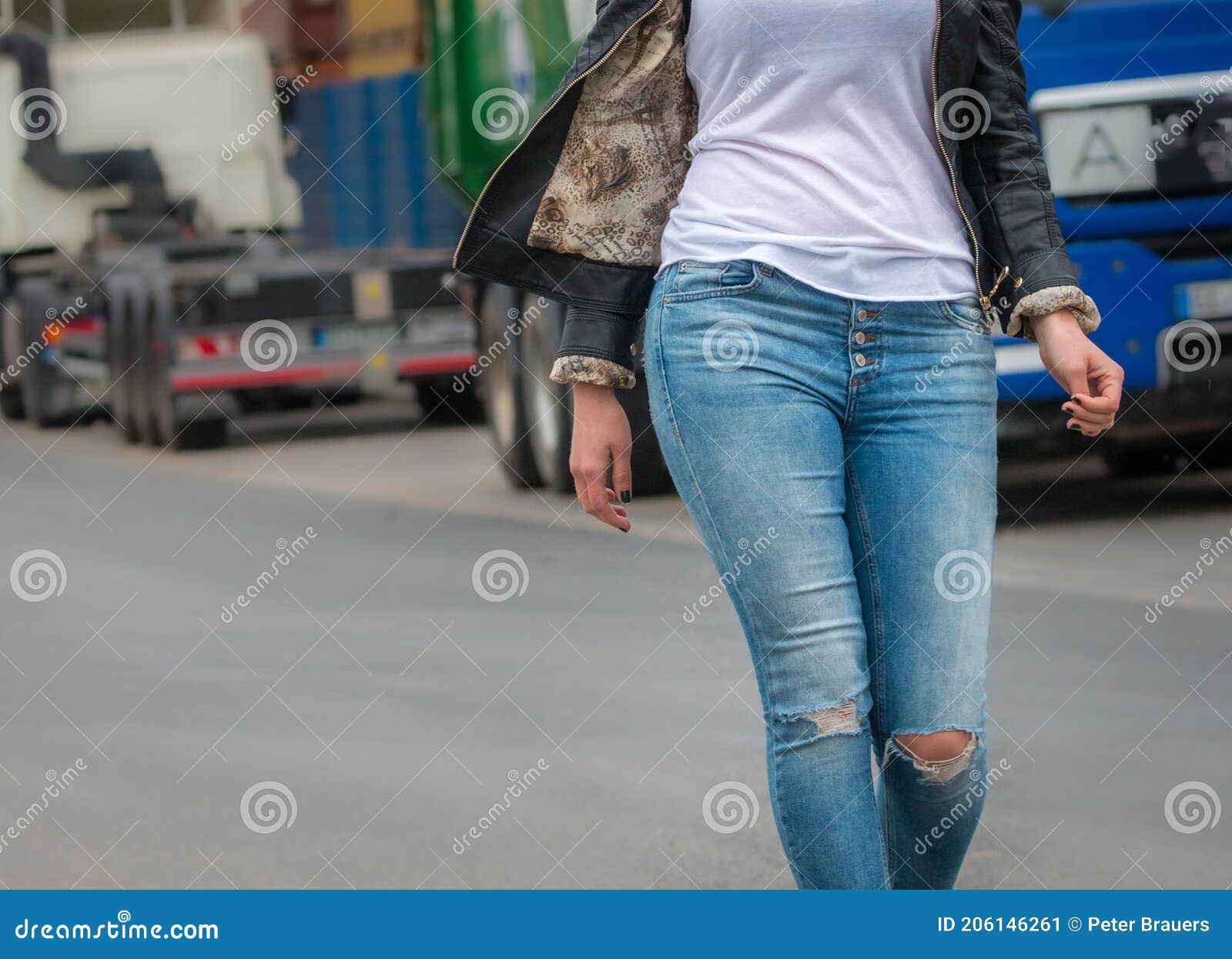 Attractive Girl In A Jeans Jacket And White T-shirt Walking Along