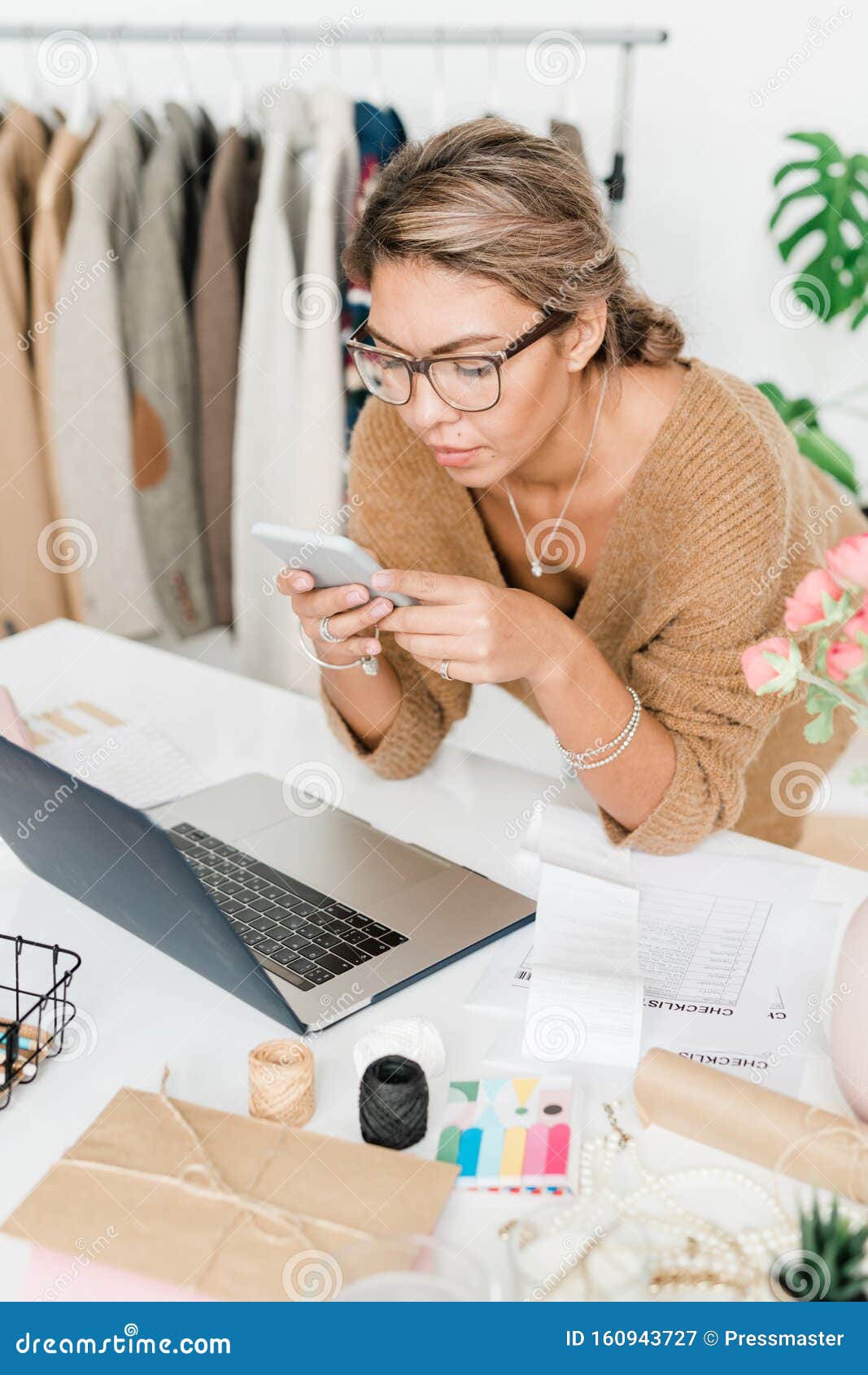 Pretty Young Casual Shop Assistant Of Modern Boutique Bending Over 