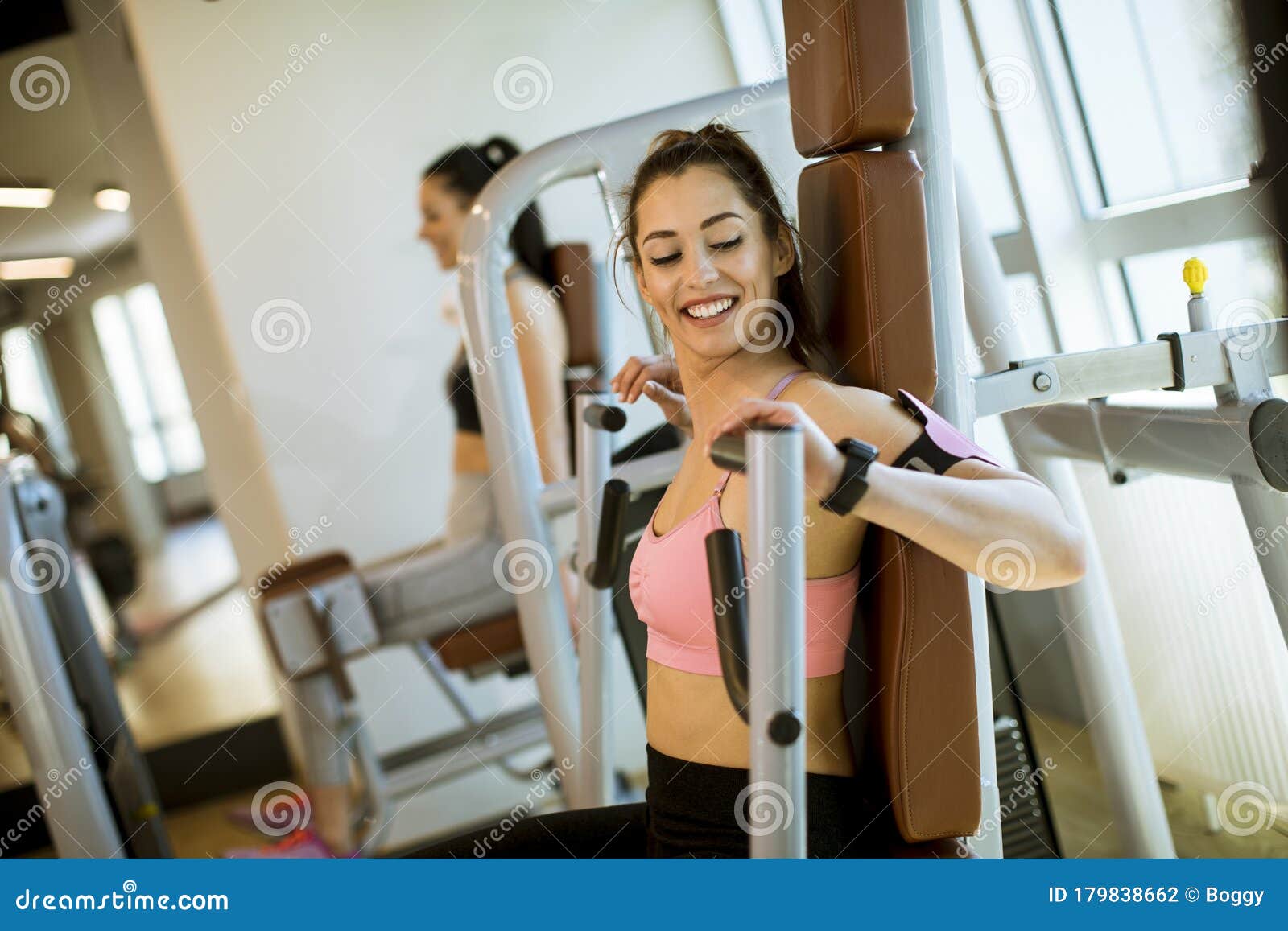 Young Determined Fitness Woman Doing Exercises at Chest Press Machine ...