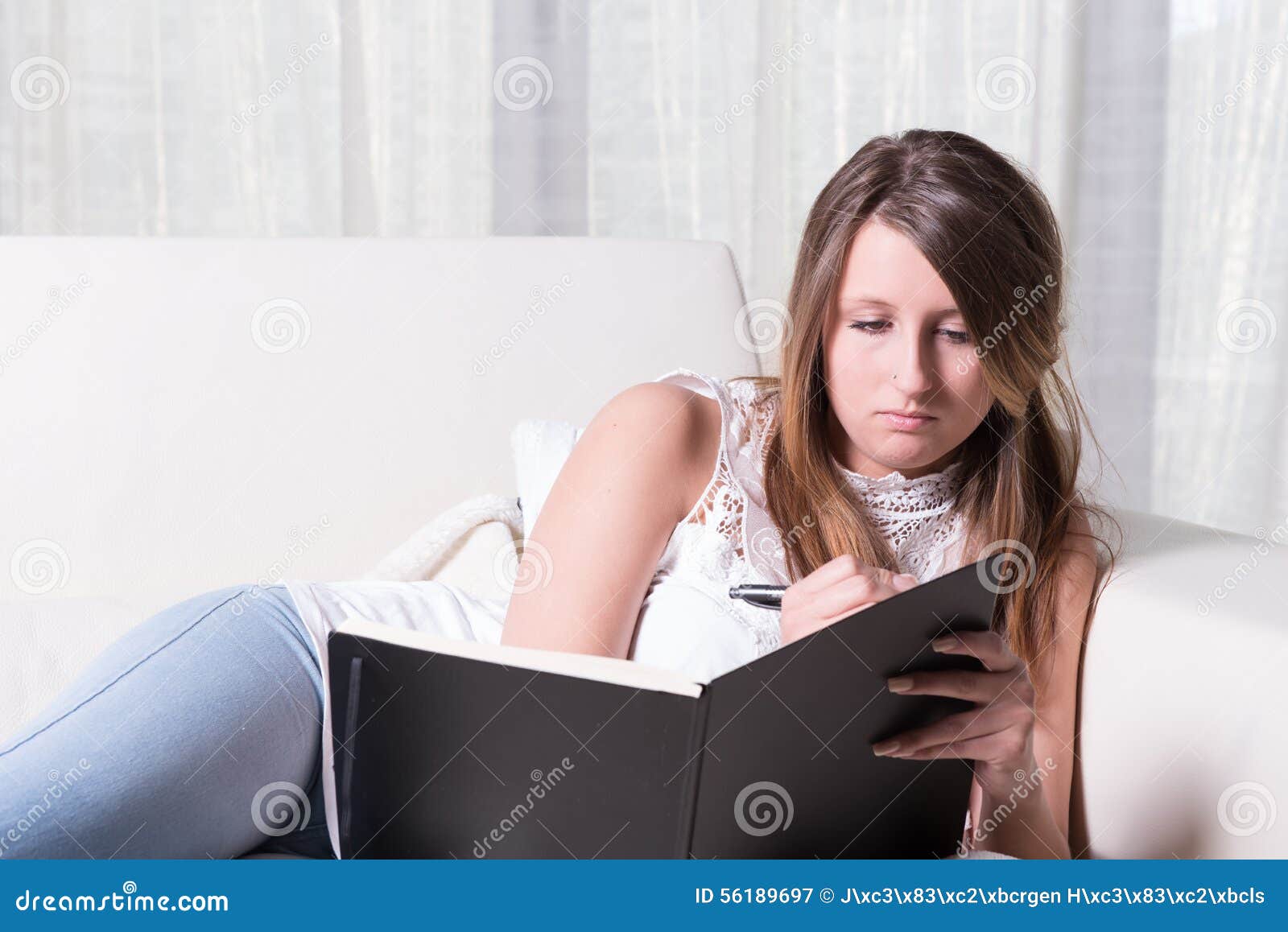 Pretty Young Girl on Couch Writing in Book Stock Image Image of