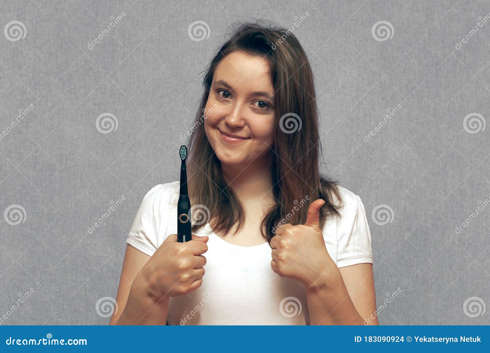 Pretty Young Girl With Electric Brush Cleaning White Teeth Stock Photo