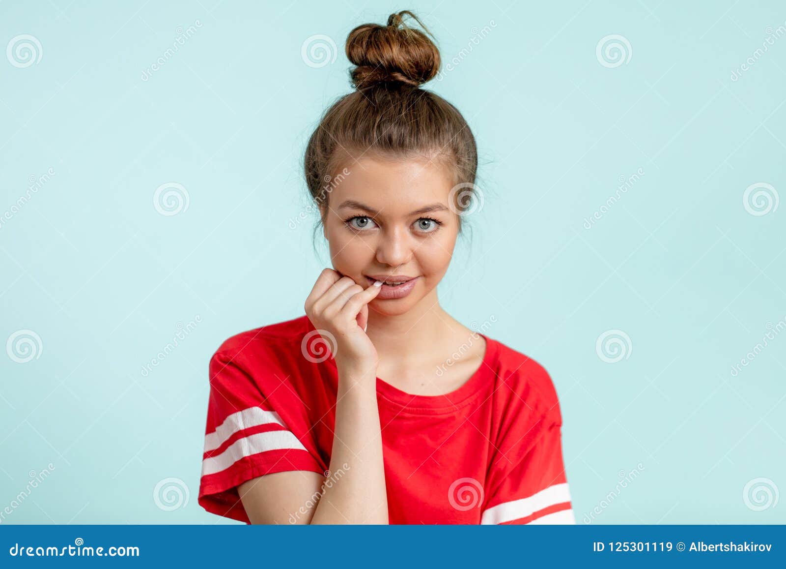 Pretty Young Girl Holding Her Finger on a Mouth and Looking at the ...