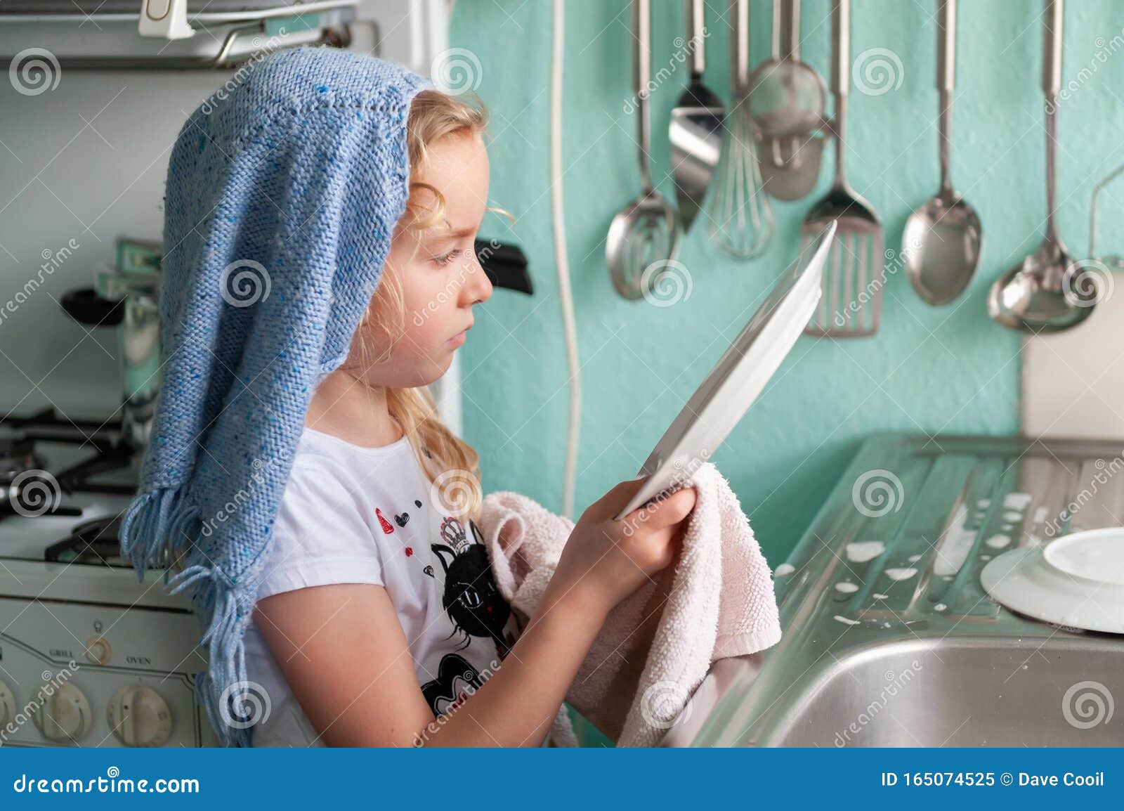 Pretty Young Girl Inspecting Dishes While Drying Up At The Kitchen Sink Stock Image Image Of