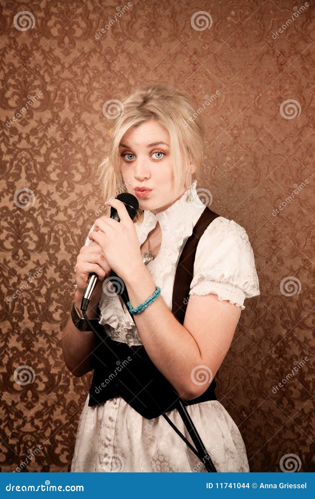 Pretty Young Singer Or Comedian With Microphone Stock Photo