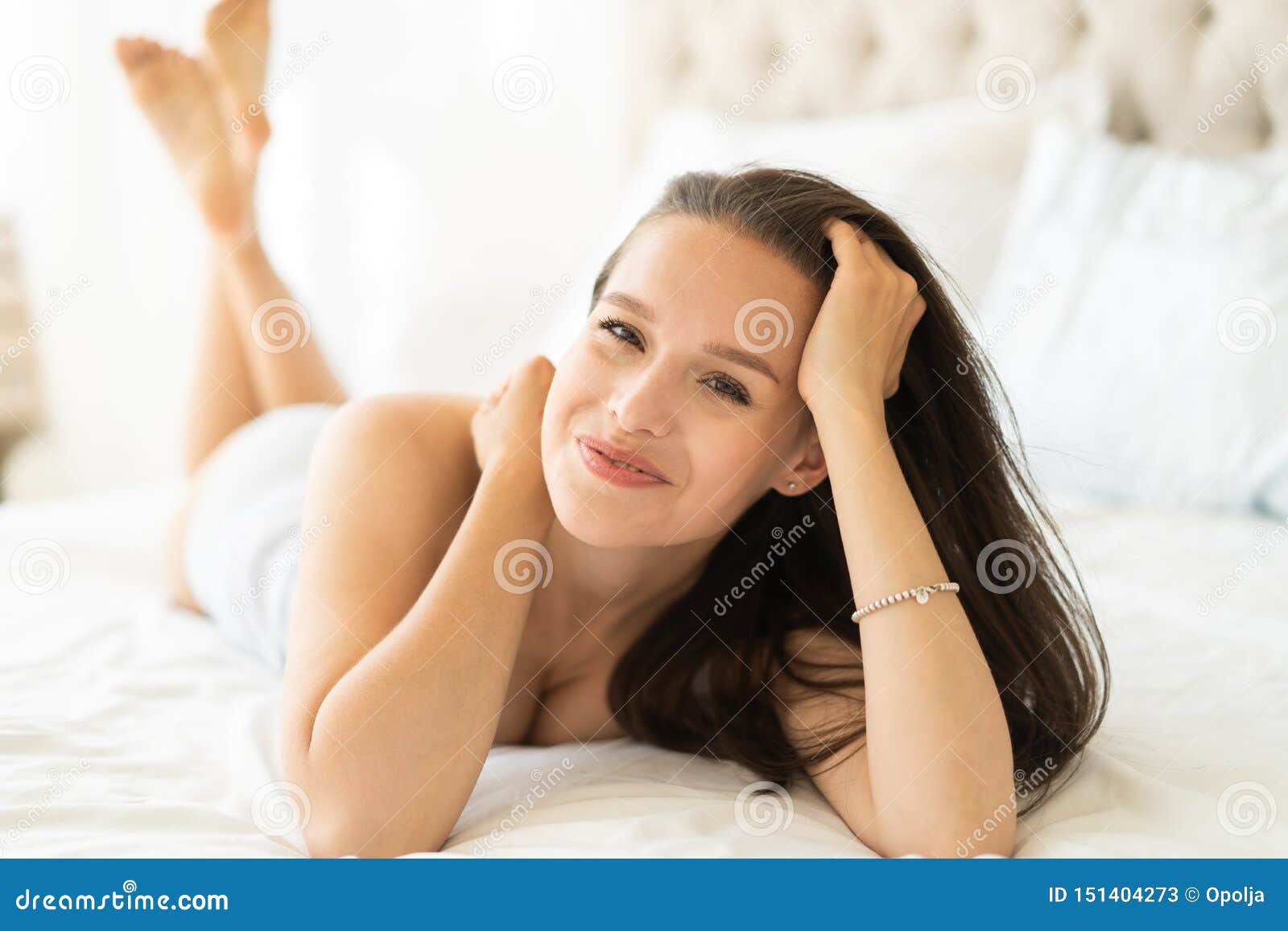 Beautiful young sensuality pretty Asian woman wearing red bra sleeping and  make happy smile on the white bed at bedroom in the morning. Stock Photo