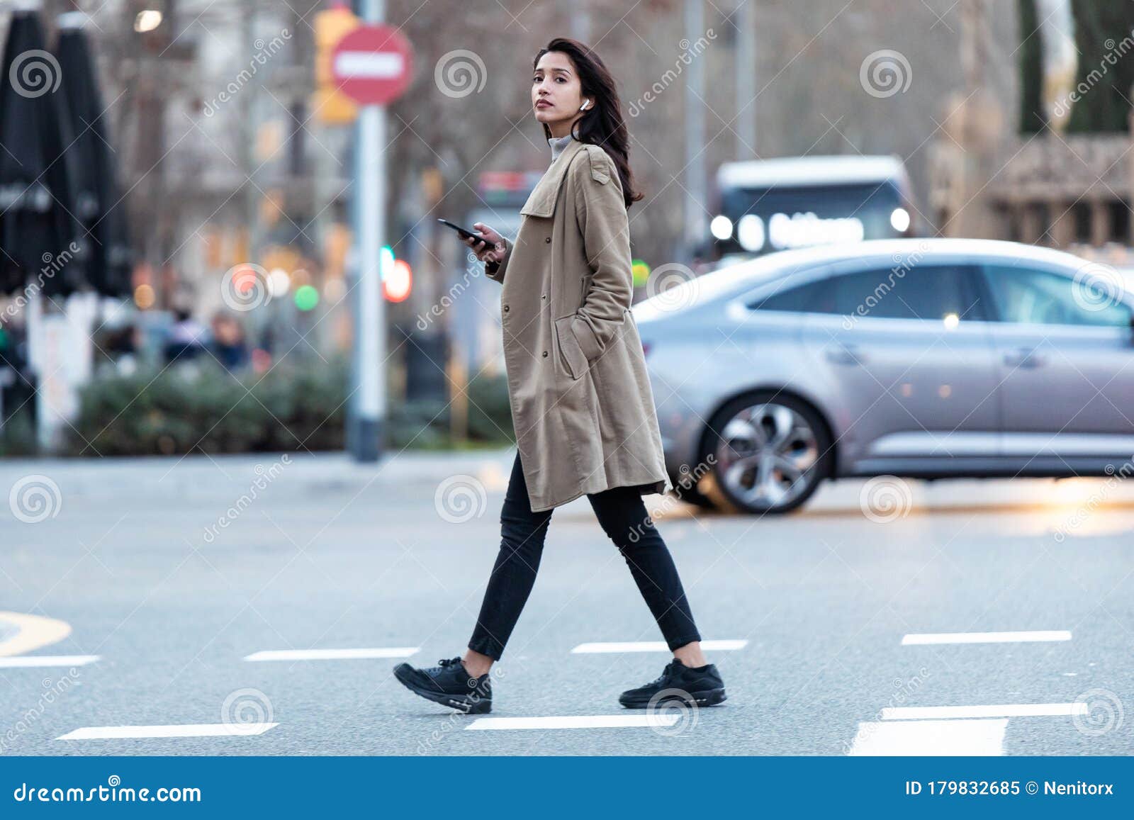 Pretty Young Woman Crossing the Street while Listen To Music with the ...