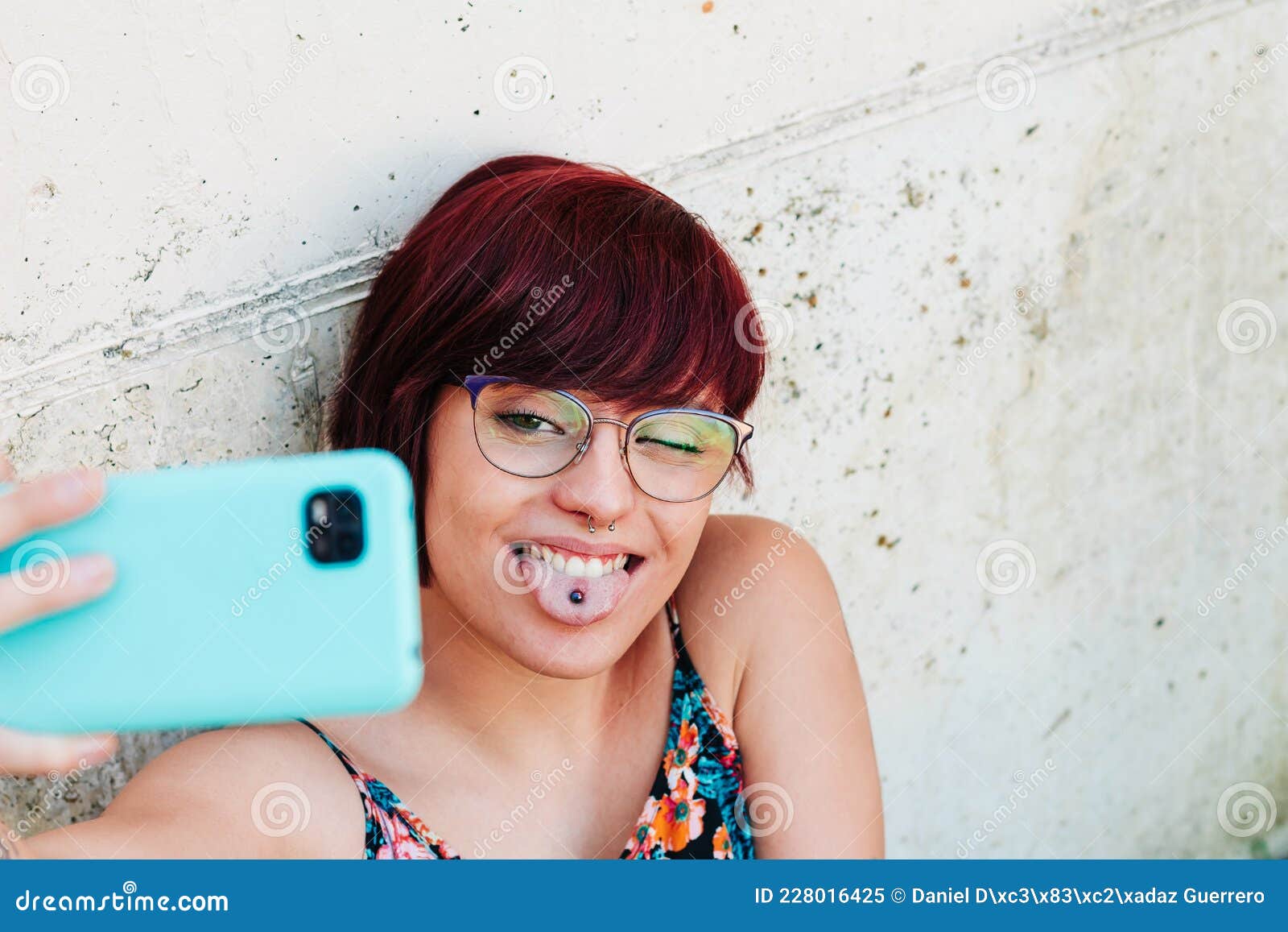 Pretty Young Woman With Earrings And Piercings On Her Face Taking A Selfie With Her Mobile Phone 