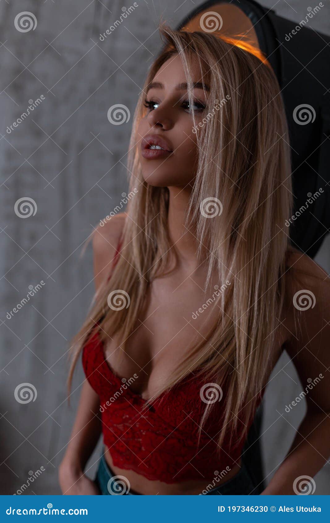 Pretty Young Woman in an Elegant Lace Red Bra with Beautiful Breasts in  Stylish Blue Jeans is Standing in a Room Near a Vintage Stock Photo - Image  of gorgeous, girl: 197346230