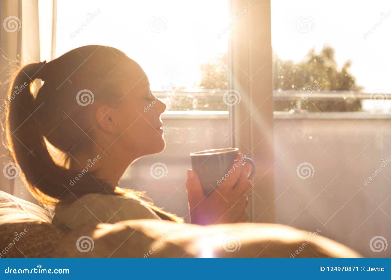 girl enjoying morning coffee in living room