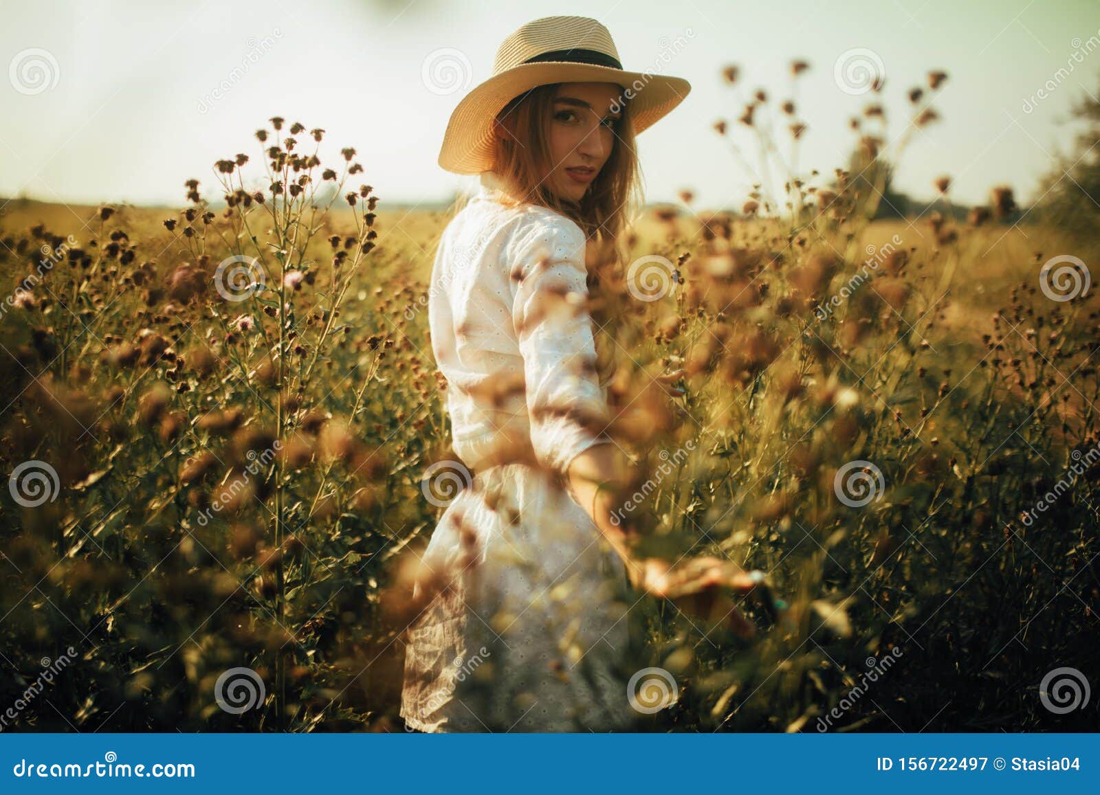 Pretty Young Woman is Walking among the Flowers on Meadow Stock Image ...