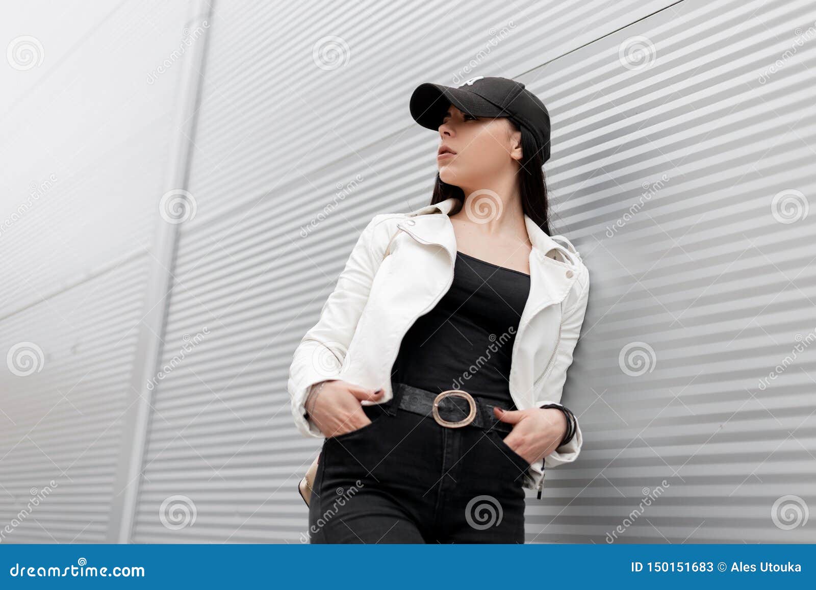 Young Woman In White Leather Jacket In A Tshirt In Black Jeans