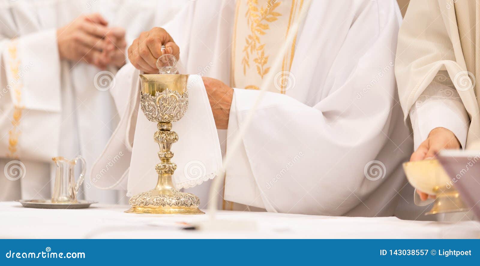 priest` hands during a wedding ceremony/nuptial mass