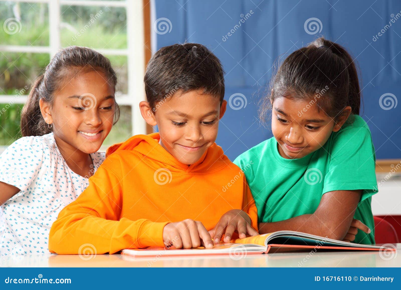 primary school children in class reading learning