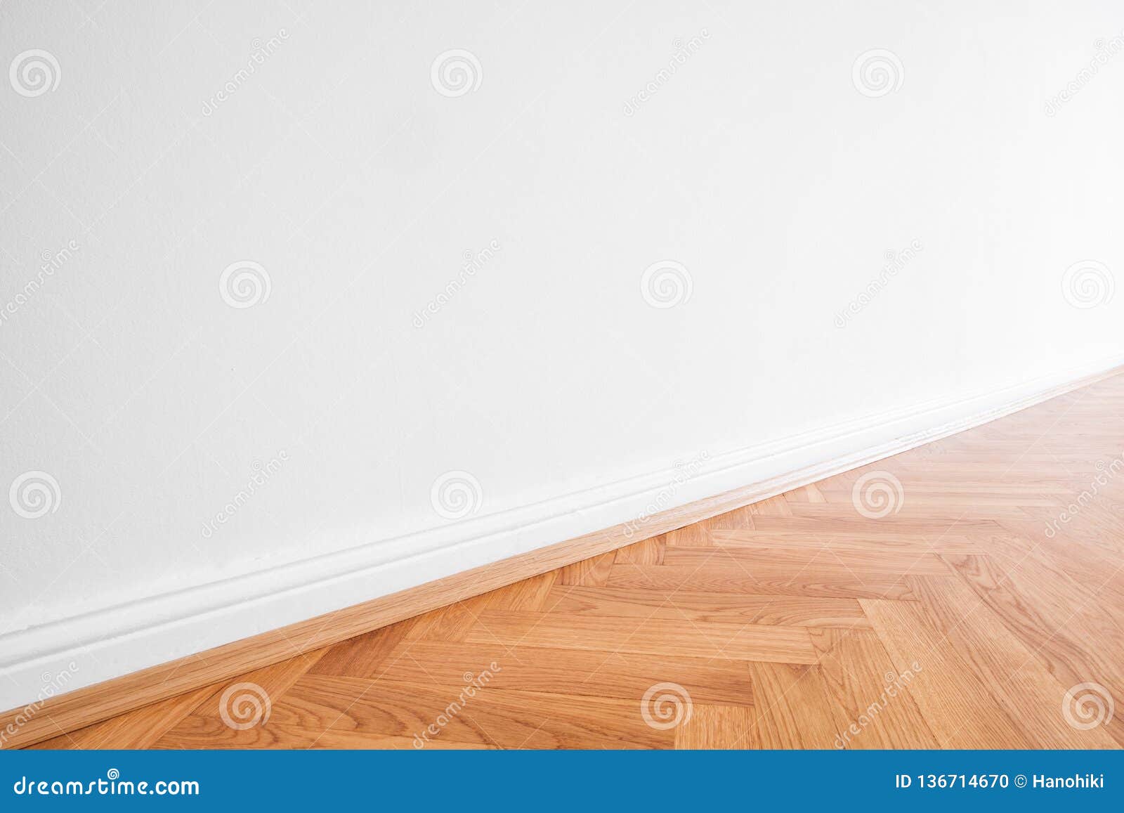 primed white wall and wooden parquet floor - apartment interior background
