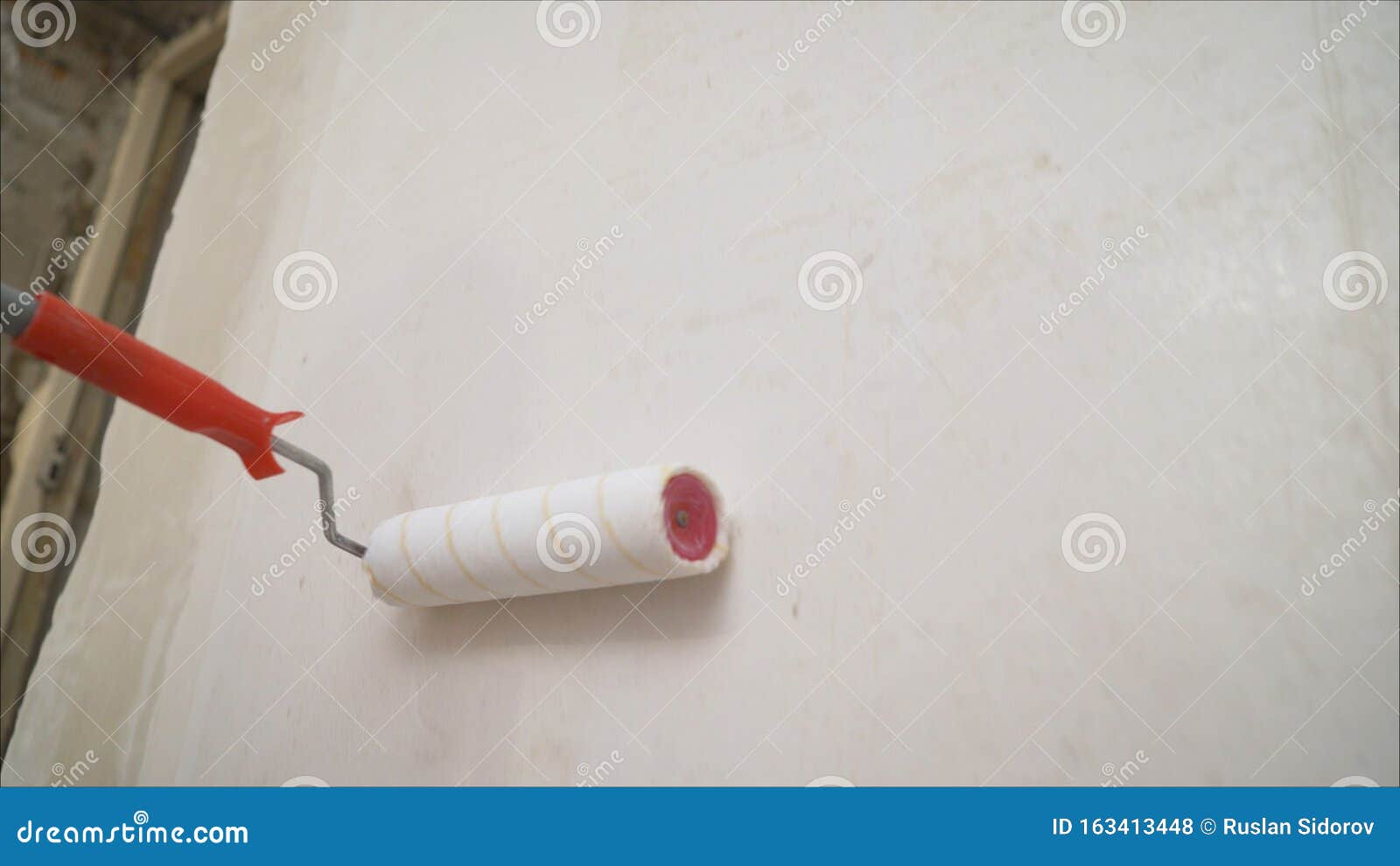 Primer on the Brick Wall with a Roller. Brick Wall Repair with Putty